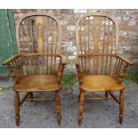 A pair of 20th century beech and elm Windsor high back Elbow Chairs with panel seats and turned