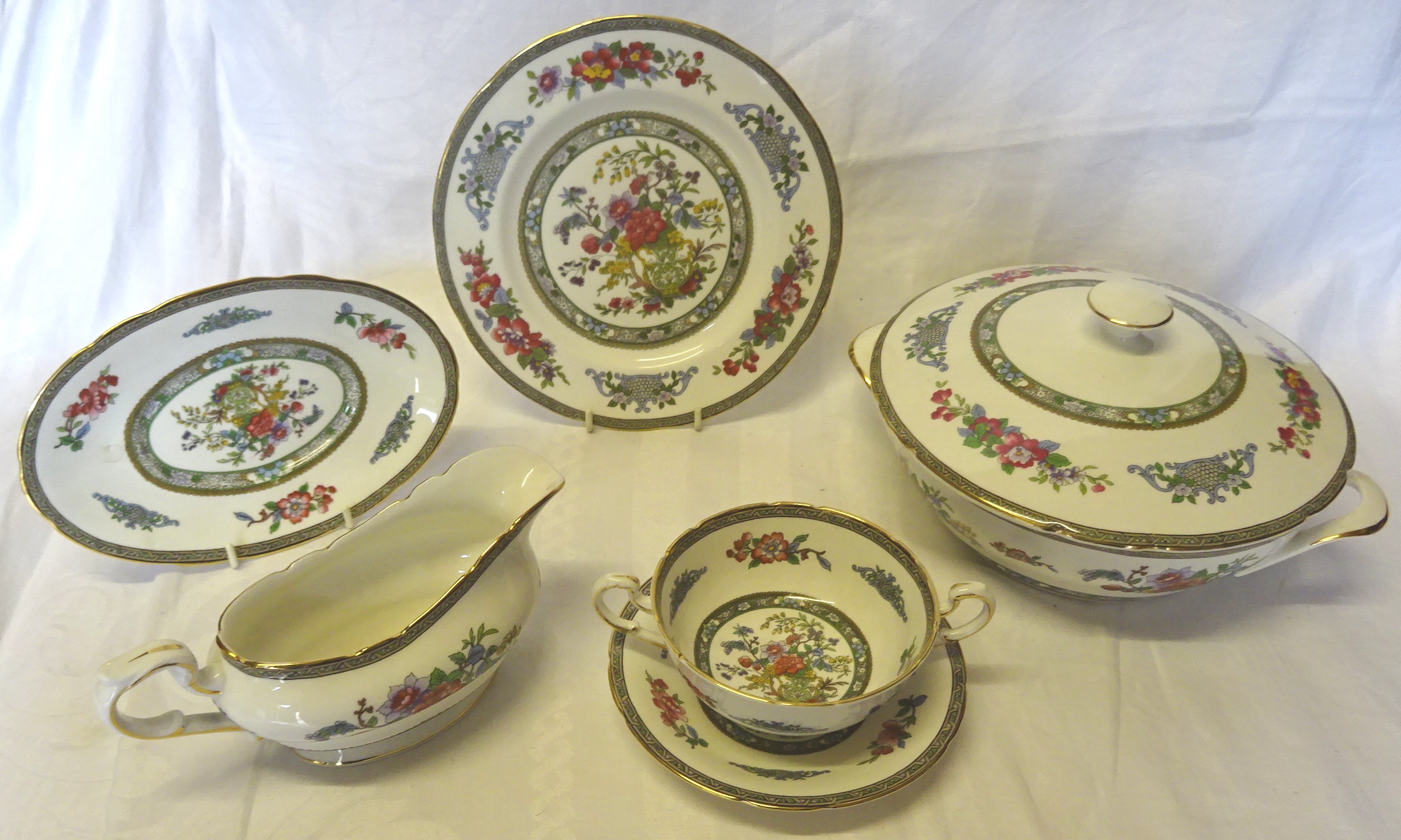 A Paragon "Tree of Kashmir" Dinner Service including plates of various sizes, soup bowls and stands,