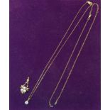 A gold Pendant set with four pearls on a fine link chain and a diamond pendant.