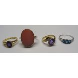 Three further 9ct. gold stone set Dress Rings and a silver Ring.