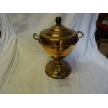 A Victorian copper two handled Tea Urn with brass tap and circular foot. 13" (33cms) high.