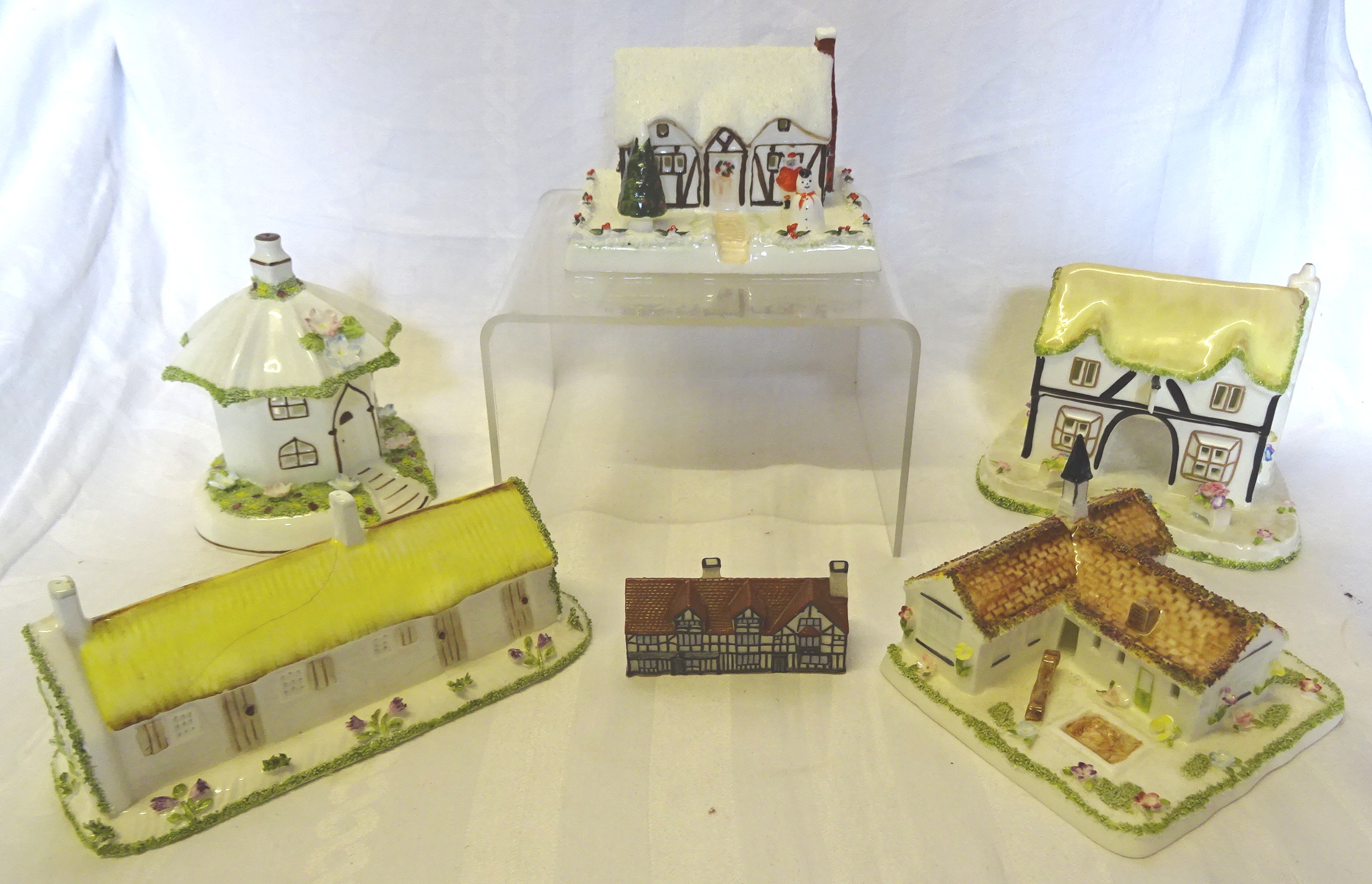 A Coalport Model of "The Village School", another "Christmas Cottage", three others (cracked), and a