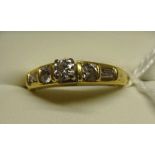 An 18ct gold Engagement Ring set with baguette and brilliant cut diamonds.