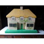 A two storey Doll's House in the form of a thatched cottage with furniture and accessories, 2' (