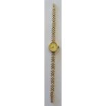 A ladies Rotary quartz Wristwatch with oval champagne dial, baton numerals in gold case and on a