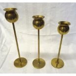 A set of three graduated Swedish brass Skultuna tulip pattern Candlesticks designed by Pierre