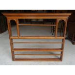 A small 19th Century oak Delft Rack, with arched recesses and open shelves beneath a stepped