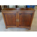 An early 19th Century oak Cupboard with mahogany banding and enclosed by pair of panel doors on