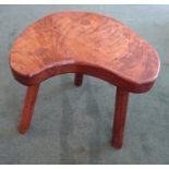 An early Thompson of Kilburn "Mouseman" dark oak kidney shape Cow Stool raised on three panel