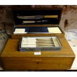 An oak Cutlery Box containing six table knives and six dessert knives with bone handles, together