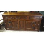 A late 18th Century oak Dresser Base with three frieze drawers above two cupboards with fielded