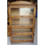A Lebus four tier oak sectional Bookcase, the upper section with a raised three quarter gallery