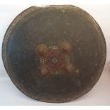 An Indo-Persian circular hide shield with four metal bosses. 21" (53cms) diameter.