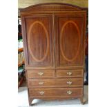 An Edwardian mahogany Linen Press inlaid with satinwood banding, the interior with sliding trays