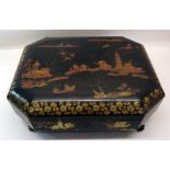 A Chinese black lacquer Games Box decorated in red and gilt with figures and buildings, the interior