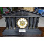 A Victorian Mantel Clock with white dial in architectural style black marble case, the dial