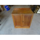 A late Victorian walnut Cupboard with a raised back and enclosed by pair of panel doors on a