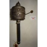 An Eastern metal Prayer Wheel with wooden handle.