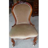 A Victorian mahogany frame spoon back Nursing Chair with carved cresting rail, upholstered seat