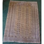 An Afghan Bokhara Rug of traditional design on a beige field and multi stripe floral border. 6'