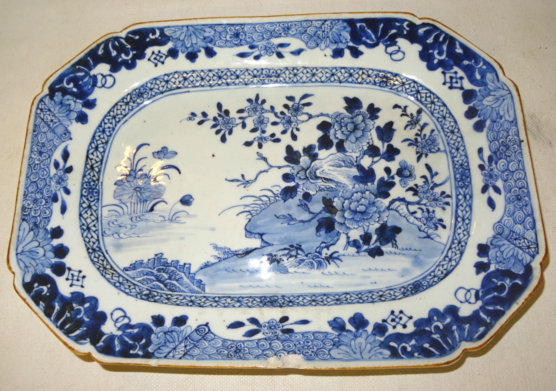 A Chinese export oblong Plate decorated in blue and white. 11 1/2" (29cms) wide (chipped).