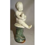 An unusual Royal Doulton figure of naked child seated on a rock with impressed mark and number '