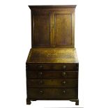 A George III oak Bureau Cabinet, the upper section with dentil cornice, mahogany banding and