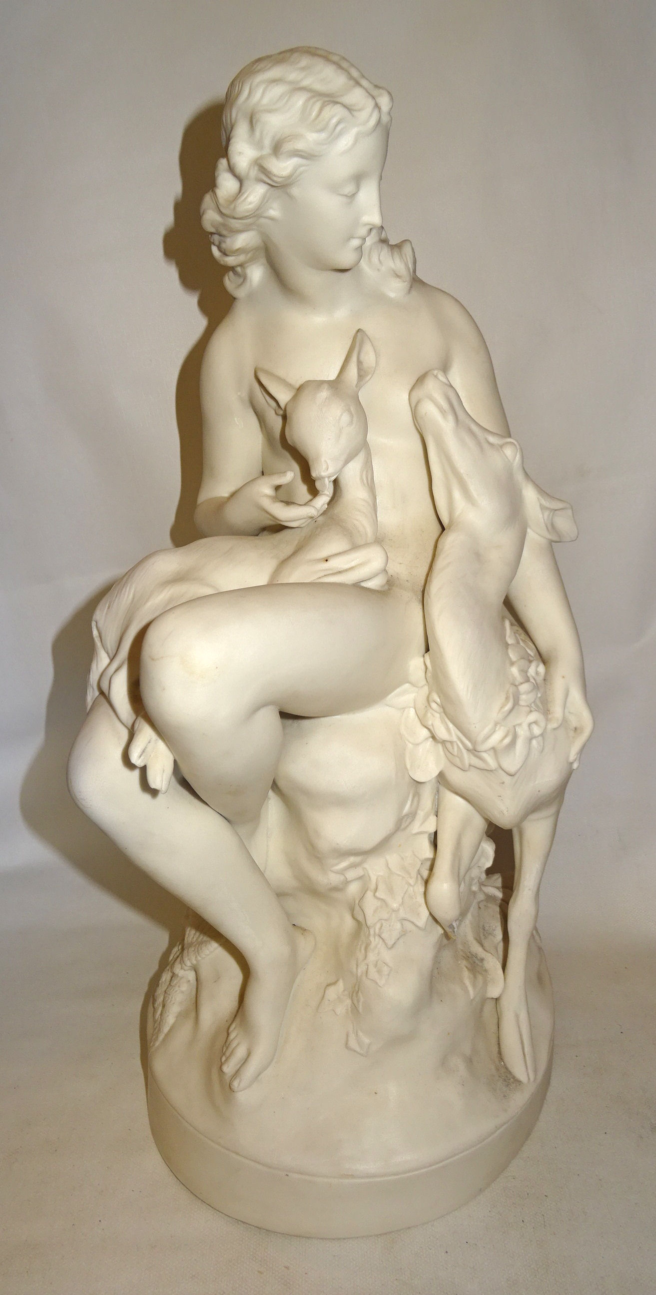 A Victorian Parian ware Figure of a wood nymph with a deer and fawn by C B Birch dated 1864. 20" (