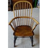 A Victorian beech and elm Windsor Elbow Chair with panelled seat and turned supports.