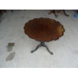 A George III mahogany circular tilt top Occasional Table with pie crust top on a baluster turned