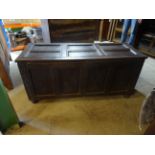 A 17th Century oak Coffer with six panel hinged top and four panel front carved with stylised