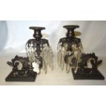 A pair of Candlesticks, each hung with button and spear cut lustre drops on bronze bases, each