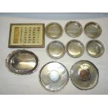 A Perpetual Calendar in silver frame, six small Mexican silver circular coasters and three Eastern