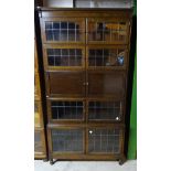 A Minty oak five tier sectional Bookcase enclosed by leaded glass and panelled doors. 2' 11" (89cms)