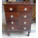 A small Chest of eight drawers with glass handles and turned supports. 20 1/2" (52cms) wide.