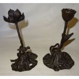 A pair of Japanese bronze Candlesticks in the form of water lilies and pads, one with a frog and the