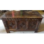 An early 18th Century oak Coffer with plain hinge lid and three panel front, with lozenge and scroll