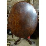 A Victorian figured walnut oval Dining Table with quarter veneered top on a baluster column and