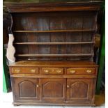 An 18th Century oak Dresser with boarded canopy Delft rack, above three frieze drawers, two cupboard