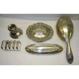 A silver backed Hairbrush and Clothes Brush, silver dressing table candlestick, silver oval