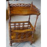 A Victorian figured walnut three division Canterbury Whatnot of serpentine outline, with pierced