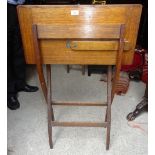 An early 20th Century oak folding Writing Table, the interior with leather mounted desk blotters,