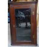 A 19th Century oak Corner Wall Cupboard with serpentine front shelves enclosed by clear glass