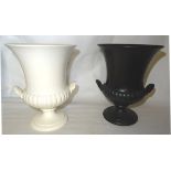 A Wedgwood campana shape Vase with shell moulded handles on a pedestal foot with white glaze. 9 1/2"