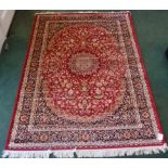 A Keshan pattern Rug with an all over floral design in red, blue, cream etc. 7' 6" (230cms) x 5'