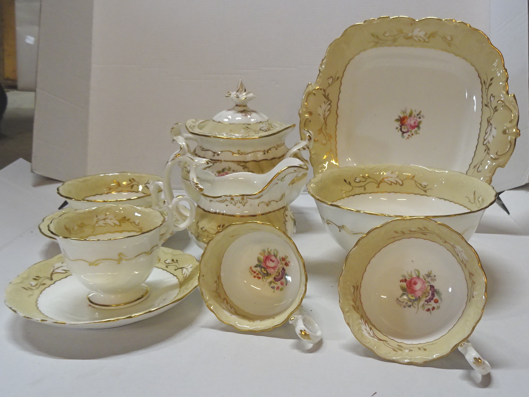 A Victorian Tea Set decorated with floral sprays within a cream and gilt border, comprising six