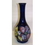 A Walter Moorcroft baluster Vase decorated with the Clematis pattern on a dark blue ground and