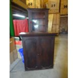 An early 19th Century mahogany Cupboard with dentil cornice, enclosed by a pair of panelled doors,