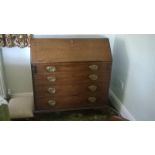 A George III mahogany Bureau with hinged fall and fitted interior, four long graduated drawers under