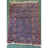 A Baluchi Rug of geometric design on a blue field and bordered. 4' 4" (132cms) x 3' 1" (94cms).